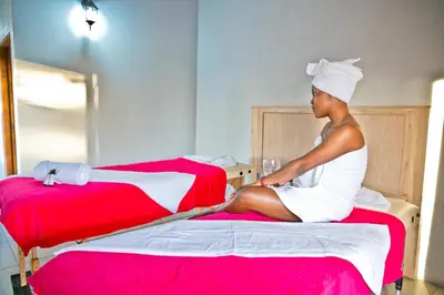 a woman sitting on a bed in a room at Collen Pillar Hotels, Windsor Royale