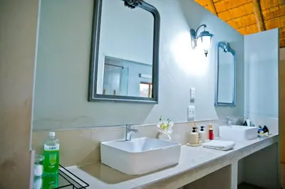a bathroom with a white sink and a mirror at Collen Pillar Hotels, Windsor Royale