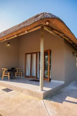 a view of a house with a thatched roof at Collen Pillar Hotels, Windsor Royale