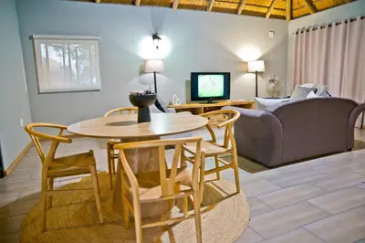 a living room with a table and chairs and a couch at Collen Pillar Hotels, Windsor Royale