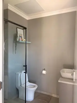 a bathroom with a toilet and a sink at 202 on Crescent - Luxury Wildlife Escape in Hartbeespoort with Magaliesberg Mountain views in Hartbeespoort