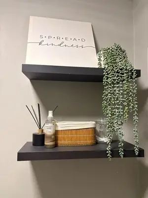 a shelf with a book and a plant on it at 202 on Crescent - Luxury Wildlife Escape in Hartbeespoort with Magaliesberg Mountain views in Hartbeespoort
