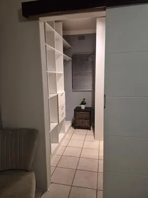 a room with a hallway with a couch and a shelf at YouRHome in Pretoria