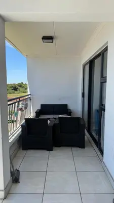 a balcony with two black couches on a balconysenalsenalsenalsenal at Lagoon Serenity Suite in Pretoria