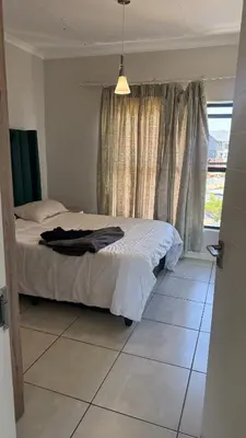 a bedroom with a bed and a window at Lagoon Serenity Suite in Pretoria