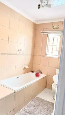 a bathroom with a tub and a toilet at 33OnPangolin B&B in Nelspruit
