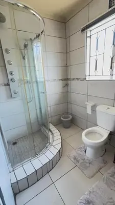 a bathroom with a shower and a toilet at 33OnPangolin B&B in Nelspruit