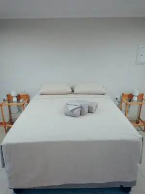 a large white bed with two pillows on it at Waterhole Lodge Unit 2 in Malelane