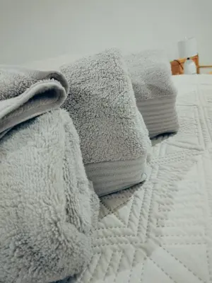 a pile of white blankets on a bed at Waterhole Lodge Unit 2 in Malelane