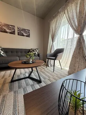 a living room with a couch and a table at The Precinct Luxury Apartments in Kyalami