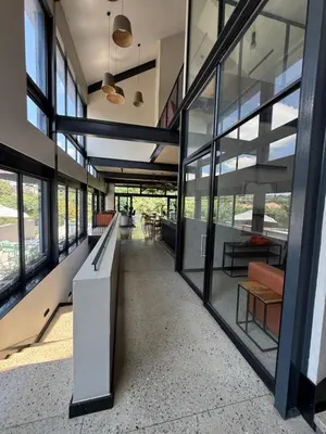 an empty hallway in a building with windows at The Precinct Luxury Apartments in Kyalami
