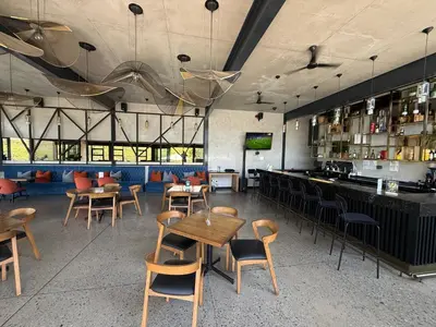 a restaurant with tables and chairs and a bar at The Precinct Luxury Apartments in Kyalami