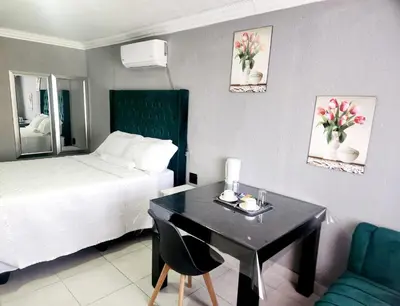 a hotel room with a desk and a bed at Kiba guest house in Marble Hall