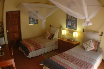 a hotel room with two beds and two lamps at Trees Too Guest Lodge in Komatipoort