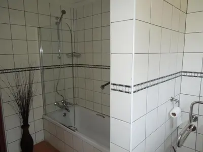 a bathroom with a shower and a tub and a sink at Trees Too Guest Lodge in Komatipoort