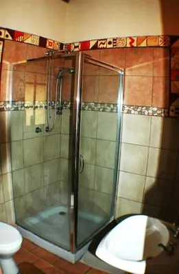 a shower in a bathroom with a toilet and a sink at Trees Too Guest Lodge in Komatipoort