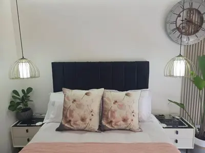 a bedroom with a bed with two pillows on it at Indulge Deluxe Accommodation in Middelburg
