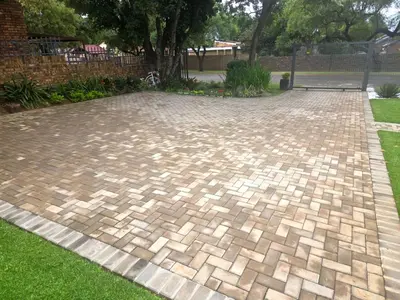 a brick driveway in a yard with grass at Indulge Deluxe Accommodation in Middelburg