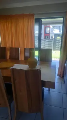 a dining room table with a vase on top of it at GP Mgudlwa in Pretoria