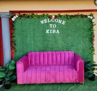 a purple couch in front of a welcome to keria at Kiba guest house