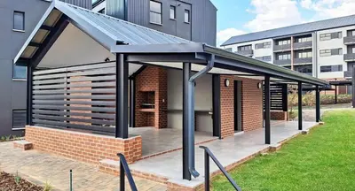 a building with a pavilion in front of a building at Home away from home in the heart of waterfall in Midrand