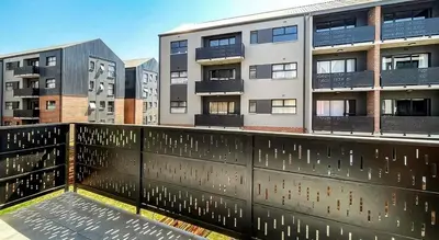 a balcony of a building with buildings in the background at Home away from home in the heart of waterfall in Midrand