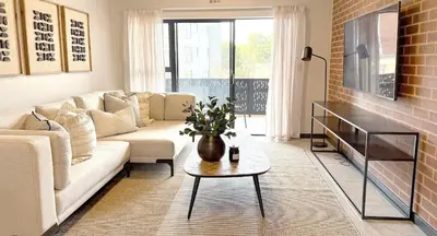 a living room with a couch and a table at Home away from home in the heart of waterfall in Midrand