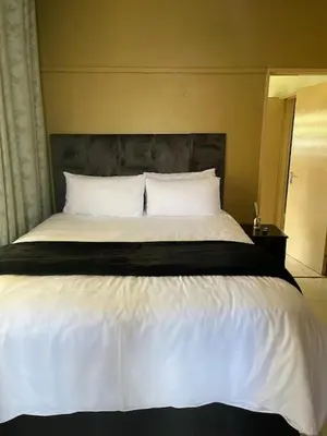 a bedroom with a large bed with white sheets and pillows at Guest house at 17 Arnot