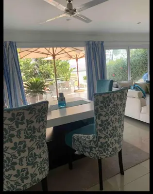 a living room with a desk and two chairs at Damview guesthouse in Hartbeespoort