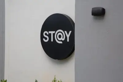 a black stop sign on the side of a building at The Regency Exclusive Apartment in Pretoria