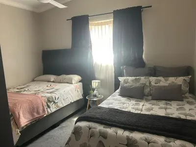 a bedroom with a bed and a window at Kumba Mzansi in Musina