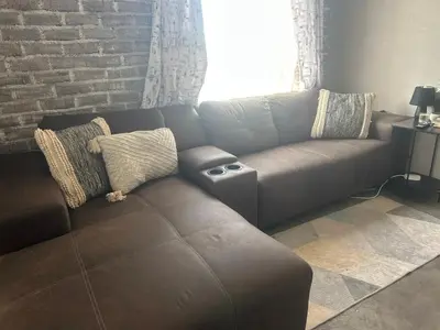 a living room with a couch and a brick wall at Kumba Mzansi in Musina