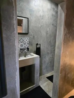 a bathroom with a sink and a mirror at Villa Calao in Marloth Park