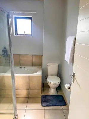 a bathroom with a toilet and a bath tub at Chillasclub BNB-SAFUBI VIEWS in Nelspruit