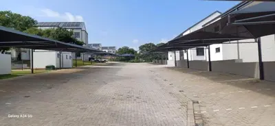 an empty street with umbrellas on the side of a building at Chillasclub BNB-SAFUBI VIEWS in Nelspruit