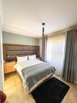 a bedroom with a large bed and a window at Chillasclub BNB-SAFUBI VIEWS in Nelspruit