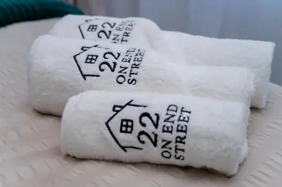 four towels with drawings on them on a bed at 22 On End luxurious & modern yet private escape in Centurion
