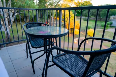 a table and two chairs on a balcony at 22 On End luxurious & modern yet private escape in Centurion