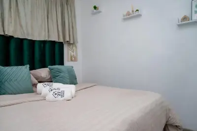 a bedroom with a bed with pillows on it at 22 On End luxurious & modern yet private escape in Centurion