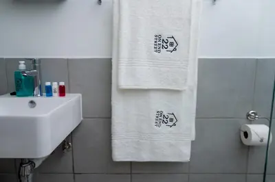 a bathroom with two towels and a sink at 22 On End luxurious & modern yet private escape in Centurion