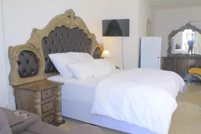 a bedroom with a large bed with a large headboard at Comfort stay Guesthouse in Mokopane