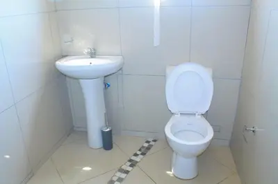 a small bathroom with a toilet and a sink at Comfort stay Guesthouse in Mokopane