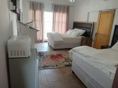 a hotel room with two beds and a laptop in it at Comfort stay Guesthouse in Mokopane