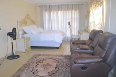 a living room with a couch and a bed at Comfort stay Guesthouse in Mokopane