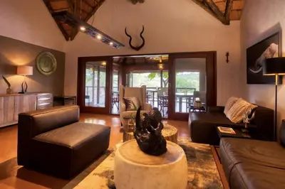 a living room with a couch and a table at Emhosheni River Lodge in Balule Game Reserve