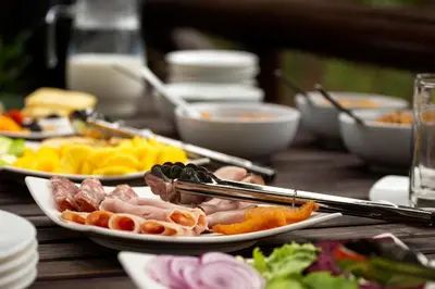 a table topped with plates of food and chop sticks at Emhosheni River Lodge in Balule Game Reserve