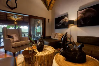 a living room with a couch and a table at Emhosheni River Lodge in Balule Game Reserve