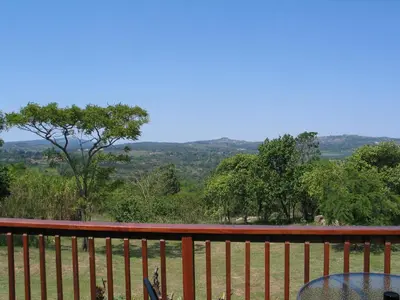 a view from the deck of a house with a table at White House Lodge in White River