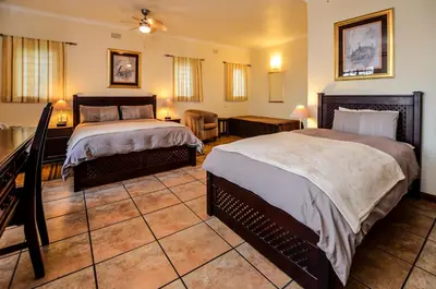 a hotel room with two beds in a room at White House Lodge in White River