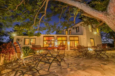 a group of tables and chairs in front of a building at White House Lodge in White River